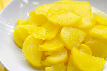 Sweet and tart slices of yellow pickled daikon, known as takuan in Japan and danmuji in Korea.
