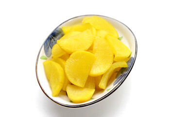 Sweet and tart slices of yellow pickled daikon, known as takuan in Japan and danmuji in Korea.