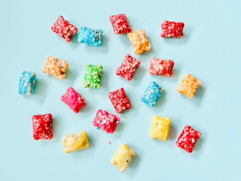 Overhead View Of Multi Coloured Sweets On A Turquoise Background