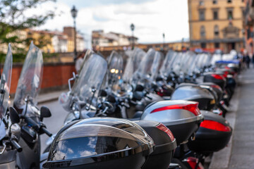 Motor scooters parked in row on road. Selective focus