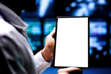 Supervisor using mock up tablet to inspect supercomputers doing complex computations. Professional...