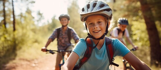 Portrait of little boy riding a bicycle with his friends - obrazy, fototapety, plakaty