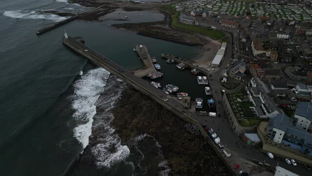 Aerial video of the fishing village of Seahouses in Northumberland, UK.