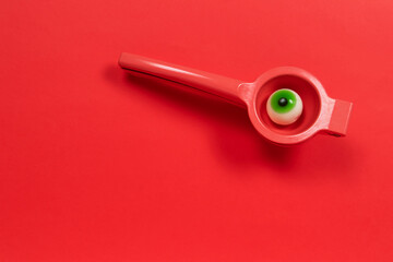 Green candy eye in a citrus squeezer