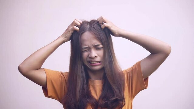 Asian woman having itchy head from dandruff