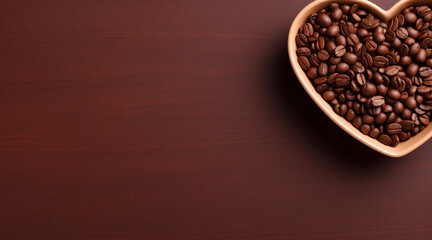 Fototapeta premium Top view of coffee grains in a heart shaped bowl on a brown background with space for text