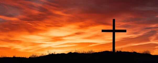 A stunning contrast between the stark, dark outline of the cross and the vibrant, golden background of the evening sky, creating a captivating composition.