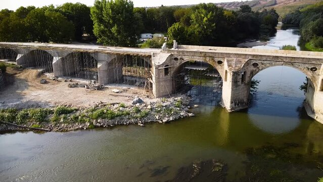 Aerial drone footage of the Bridge by Master Kolyo Ficheto at Byala - Bulgaria. 4k high angle shot of the reconstruction and repair of the Belenski Most over Yantra river.
