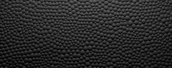 Dotted rubber texture A textured black rubber with evenly spaced raised dots, giving the surface a dotted appearance. The texture is sy and adds traction.
