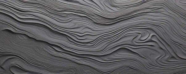 Texture of a tree bark with a intricate pattern of swirls and loops in varying shades of grey and charcoal. The surface is surprisingly smooth and cool to the touch, with a matte finish.