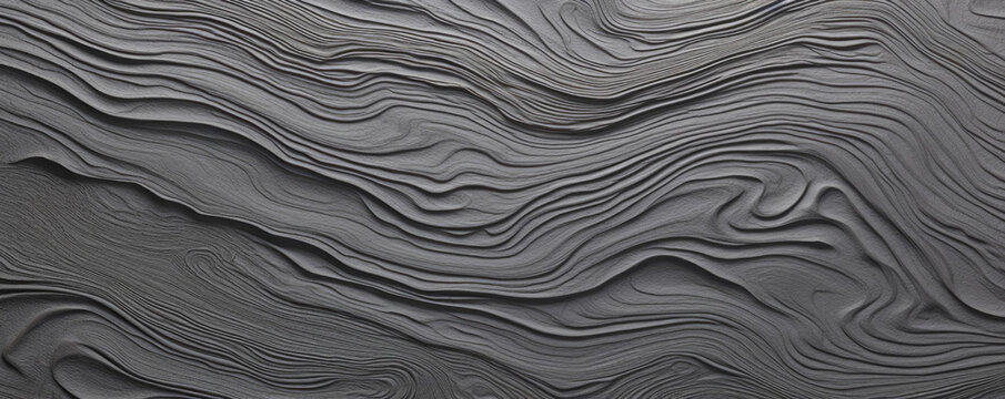 Texture Of A Tree Bark With A Intricate Pattern Of Swirls And Loops In Varying Shades Of Grey And Charcoal. The Surface Is Surprisingly Smooth And Cool To The Touch, With A Matte Finish.