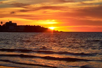 Fotobehang red sunset in the sea of cuts in mazatlan sinaloa © Alex Borderline