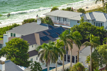 Aerial view of expensive american home roof with blue solar photovoltaic panels for producing clean...
