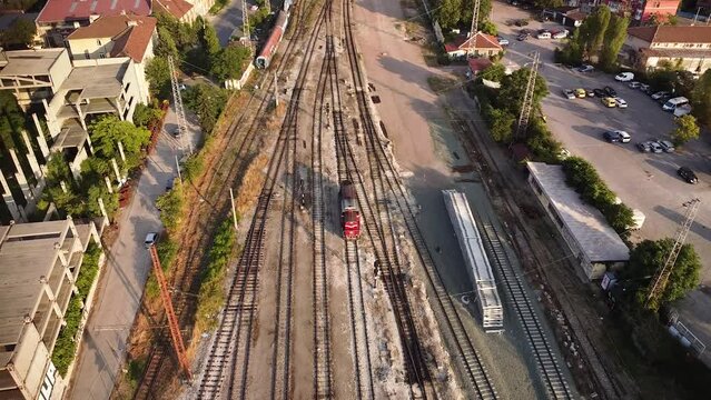 High angle 4k aerial drone footage of Train tracks, locomotives and wagons at Sofia central station railway depot and train yard. Rail infrastructure seen from above. 
