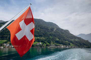 A Swiss flag at the stern of a passengers boat on the lake of Lucerne, Switzerland.