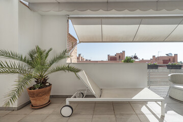 terrace with white awnings and white wooden furniture combined with a white and gray hammock with...