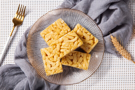 Chinese traditional dessert caramel treats or sachima on table.