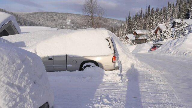 Vehicles Buried Under Thick Blanket of Snow in Mountainous Region