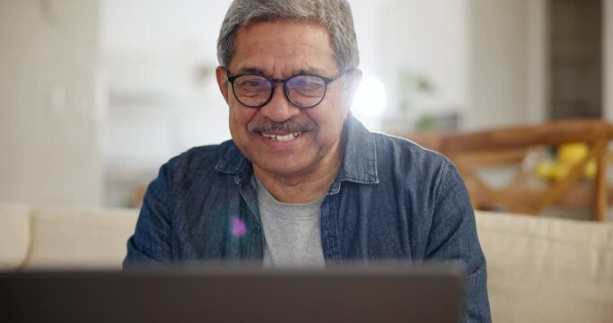 Laptop, smile and a senior man streaming a subscription service in the living room of his home to relax. Computer, series or entertainment with a happy elderly person watching a movie or video