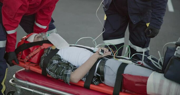 Accident, emergency and patient on stretcher for injury, first aid and car crash for saving patient with iv drip. Paramedic, ambulance and health emt with person for medical service, care and rescue