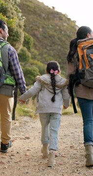 Holding hands, fitness and family on hike in nature, walk and fun for child, bonding and love in childhood. Happy parents and daughter, travel and adventure in trek, vacation and holiday on mountain
