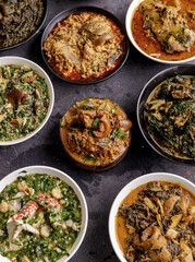Popular Nigerian SOup 'Nkworbi', Served in a traditional wooden bowl, surrounded by other popular Nigerian soup
