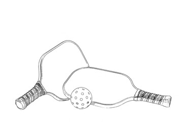 Two Black and white Pickleball paddels with pickleball and a white background.
