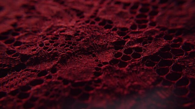 Close up shot of red textiles fabric with lace and interesting patterns