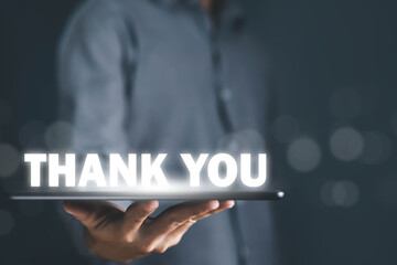 tablet shows the message thank you on a display screen. concept of thank you business,...