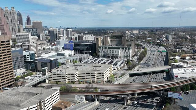 Aerial timelapse of Downtown Atlanta highway traffic during rush hour, Atlanta skyline buildings on a sunny afternoon