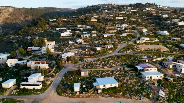settlement in Israel In Gush Etzion near Hebron.
Bat Ha'Ein is an ecological settlement, light construction to preserve nature.
Sunset during magic hour.
aerial drone view.