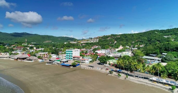 Hotel resort with large empty beach in San Juan del Sur, Nicaragua, aerial orbit