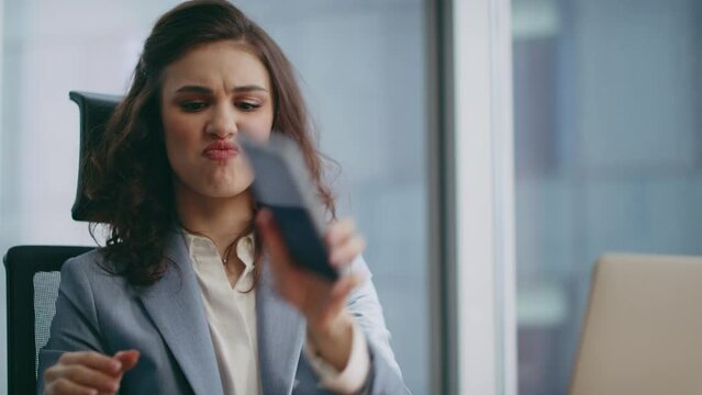 Furious businesswoman shouting smartphone conversation sitting office close up.