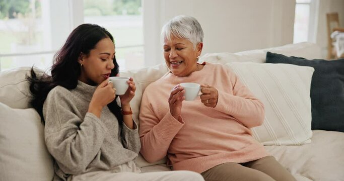 Coffee, discussion and woman with senior mother on sofa in the living room for bonding together. Happy, love and female person drinking latte, relax and talking to elderly mom in retirement at home.