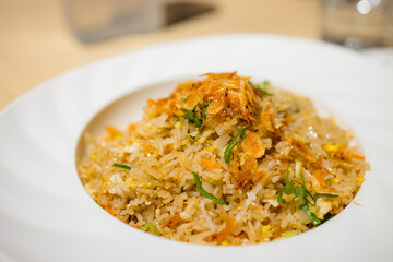 Fried rice on a white plate with dries shrimp