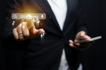 Woman touching to search engine bar with 2024 trends wording for marketing monitor and business planing in new year concept. Finding information and new ideas for doing business in 2024.