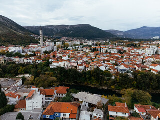 Naklejka na ściany i meble Aerial view of the city of Mostar and Neretva river, old Bridge, Koski Mehmed Pasha Mosque. Bosnia and Herzegovina