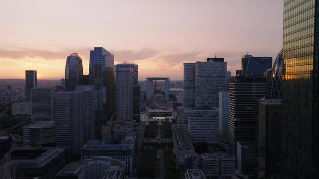 Rows of modern high rise office buildings in business district. La Defense borough against sunset sky. Paris, France