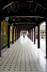Hallway with wooden pillars on the side inside Hue Citadel, Vietnam