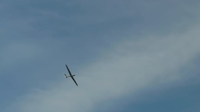 A glider (sailplane) flying in the sky.