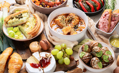 Different kinds of cheeses, baguettes and snacks. French tasting party.