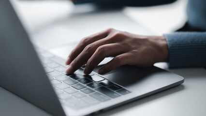 Businesswoman hands using laptop computer placed on desktop.