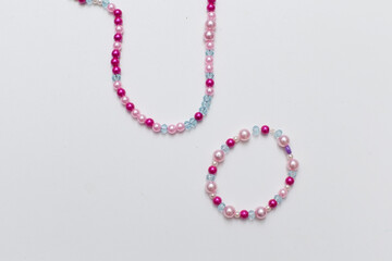 Kids handmade beaded jewelry. Necklaces and bracelets made from multicolored beads and pearls. DIY bracelet beads. Children's needlework. Creativity and hobby. Art activity for kids