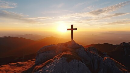 Christian cross in the peak of a mountain at sunset. - obrazy, fototapety, plakaty