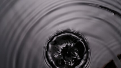 Monochrome water surface with big crown splash and circles, abstract background, wallpaper template.