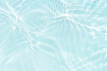 Defocus blurred transparent blue colored clear calm water surface texture with splashes reflection. Trendy abstract nature background. Water waves in sunlight with copy space. Blue watercolor shine.