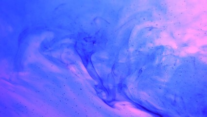 Beautiful neon purple colored water surface with blue ink flows abstract wallpaper background template.