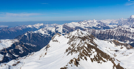 Fototapeta na wymiar The mountain view of alpine as snow-capped mount peaks in Winter mountains