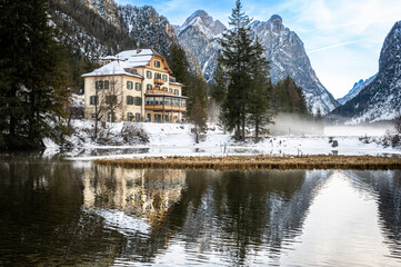 Lake Dobbiaco. Treasure chest among the Dolomites. Winter atmosphere.