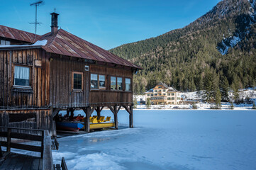 Lake Dobbiaco. Treasure chest among the Dolomites. Winter atmosphere.